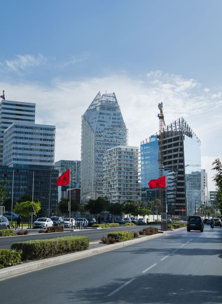 Modern towers in Casablanca with Moroccan flags